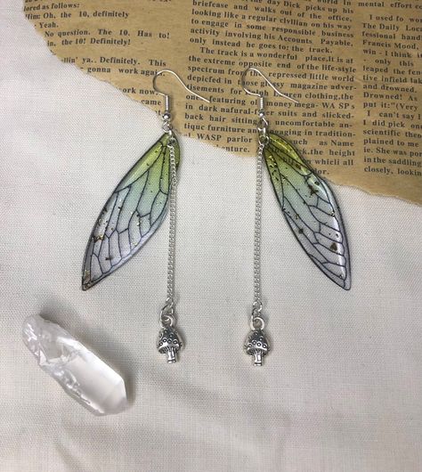 Beautiful green fairy wing earrings  ️  With gold detailing , Sliver chain and mushroom charm 🍄  Sterling silver hooks  Handmade to order  Free postage  If you have any questions please don't hesitate to message 🌿 Green Fairy Wings, Cottage Forest, Fairy Wing Earrings, Grunge Earrings, Cottagecore Earrings, Cottagecore Jewelry, Fairycore Fairy, Green Fairy, Wing Earrings