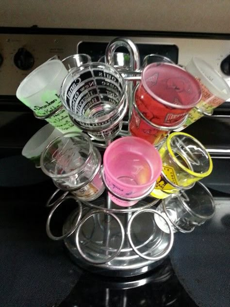 I used my Keurig K-cup holder to hold shot glasses for parties! Bar Glasses Storage Ideas, Fun Shot Glasses, Koozie Storage Ideas, Drink Storage Ideas, Diy Basement Bar, Shot Glass Display, Shot Glass Holder, College House Decor, Vase Centerpiece