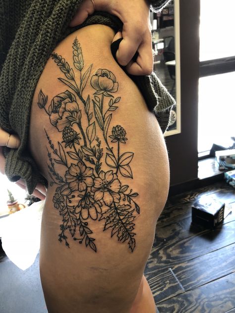 Boho Hip Tattoos Women, Side Thigh Cover Up Tattoos Women, Women’s Hip And Thigh Tattoos, Wild Flower Tattoo Thigh, Thigh Garden Tattoo, If You Go Down Im Going Down Too Tattoo, Hip Tattoo Inspiration, Hip Tattoo Wildflower, Large Wildflower Tattoo