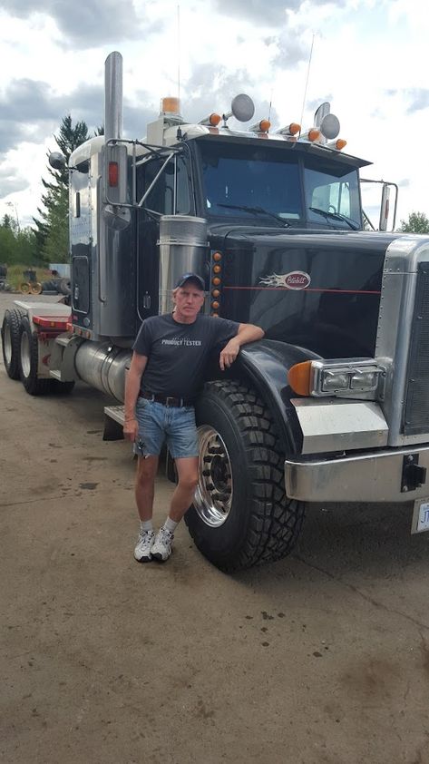 🚚 Road King: Life on the Highway with a Classic Peterbilt 🛣 Proudly leaning on his trusty Peterbilt, a seasoned trucker takes a moment to pose. His rig, a symbol of enduring strength 🏋‍♂, mirrors his own resilience. With years of experience etched into both man and machine, they stand ready to conquer the endless roads ahead. 🌟 Truck Seller Man Picture, Truck And Truckers, Trucks For Sell, Man And Machine, Dont Touch My Phone Wallpaper, Truck For Sale, African Sculptures, New Photo Download, Big Rig Trucks