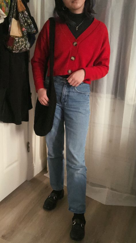 girl standing in a cropped red sweater over turtleneck with blue jeans and black loafers, holding a black tote bag Red Sweater Black Jeans Outfit, Red Sweater Blue Jeans Outfit, Layered Black Turtleneck Outfit, Red Cropped Cardigan Outfit, Outfits With Red Turtleneck, Sweater And Loafers Outfit, Target Work Outfit Red And Jeans, Turtleneck Cardigan Outfit, Red Sweatshirt Outfit Winter