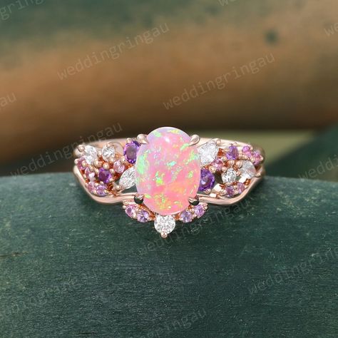 Oval cut Pink Opal Engagement ring set Vintage Rose gold Bridal ring set Amethyst ring Pink sapphire wedding ring set Diamond Promise ring ----------Rings Details ---------- The Engagement Ring: ☆Center stone: Lab Pink Opal ☆Size: 6*8mm ☆Cut Type: Oval cut ☆White stones: Moissanite or Diamonds ☆Colored stones: Amethyst & Pink Sapphire ☆Stone weight: About 0.32ct ☆Band Width: Approx. 1.5mm ☆Band Thickness: Approx. 1.2mm ☆Height of Stone setting: 6.4mm The Wedding Band: ☆Colored Stones: Amethyst & Morganite Wedding Ring Set, Pink Opal Wedding Ring, Pink Sapphire Wedding Ring, Wedding Rings Pink Sapphire, Sapphire Wedding Ring Set, Opal Engagement Ring Rose Gold, Fire Opal Engagement Ring, Pink Opal Ring, Opal Engagement Ring Set