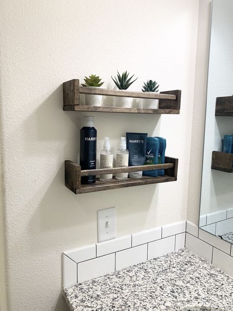 The IKEA Bekvam spice rack is a cheap solution to a lack of bathroom storage. My husband’s sink doesn’t have a drawer so we bought this spice rack and stained it to match our cabinets. No more mess on the counter! #winwin Ikea Spice Rack As Shelf, No Cabinet Bathroom Storage, Ikea Restroom Ideas, Bathroom Ikea Shelf, Small Sink Storage Bathroom, Bathroom Shelf By Sink, Bathroom Shelves By Sink, Ikea Spice Rack Bathroom, Floating Shelves Bathroom Sink