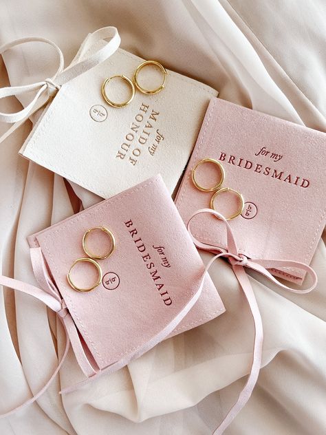 "A Bridesmaid gift they'll actually want to keep/wear!! (Louder for the ladies in the back). These gorgeous gold hoops come inside the perfect dainty little pouch. The perfect addition to any bridesmaid gift or proposal box. DETAILS: EARRINGS - 925 Sterling Silver coated in 18k Gold, 18mm BRIDESMAID POUCH - blush pink with \"FOR MY BRIDESMAID\" imprinted on front MOH POUCH - ivory with \"FOR MY MAID OF HONOUR\" imprinted on front Each set comes with one pair of earrings inside one pouch." Bridesmaid Gifts From Bride, Maid Of Honor Gift, Bridesmaid Earrings Gold, Bridesmaid Boxes, Bridesmaid Inspiration, Bridesmaid Gifts Jewelry, Bridesmaid Proposal Box, Bridesmaid Proposal Gifts, Maid Of Honour Gifts