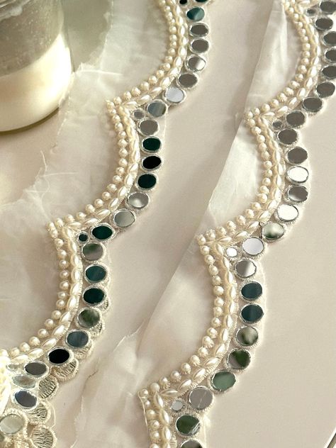 2.5cm Elegant White Pearl and Mirror Scalloped Trim - Indian Ribbon for DIY Sewing, Crafting, Dupatta Neck, Drapery, Lampshade Lace by Yard Enhance your projects with this stunning 2.5cm Elegant White Pearl and Mirror Scalloped Trim. Perfect for adding a touch of sophistication to dupattas, necklines, and drapery, this Indian ribbon is ideal for various crafting applications ✨. Materials: Pearls Mirror Accents Durable Lace Fabric Uses: DIY Sewing: Perfect for embellishing garments. Dupatta Neckl Mirror Design Dress, Mirror Suit Design, Mirror Work On Dupatta, Semi-stitched Dupatta With Pearl Embroidery For Wedding, White Dupatta With Pearl Embroidery, Pearl Dupatta, Elegant Lace Dupatta With Pearl Embroidery, Bollywood Style White Pearl Embroidered Fabric, Mirror Work Lace Border