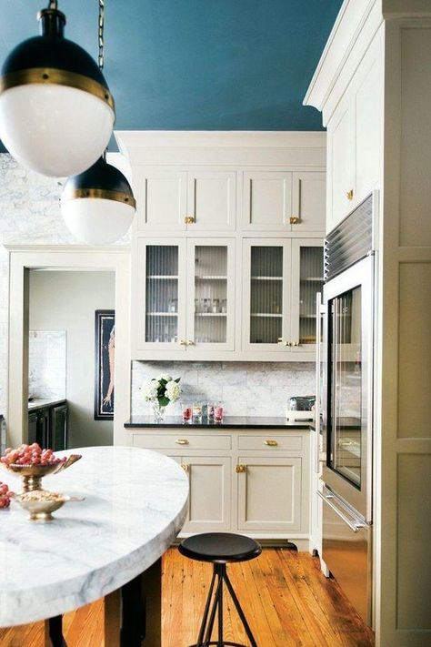 Paint the Ceiling | Brighten up! The kitchen is the room where my family spends the most time, and with open floor plans at peak popularity (partially thanks to Joanna Gaines), kitchens aren’t strictly reserved for cooking. Since guests and family always end up in the kitchen, you'll want it to be one of the prettiest rooms in the house. White kitchens are all the rage, and we agree, they are beautiful. But you might miss happy yellows and cool blues as you look around that all-white room. Kitchen With Blue Ceiling, Light Walls Darker Ceiling, Coloured Ceiling Kitchen, Blue Ceiling Kitchen, Painted Ceiling Kitchen, Blue Kitchen Ceiling, Painted Kitchen Ceiling, Coloured Ceilings, Darker Ceiling