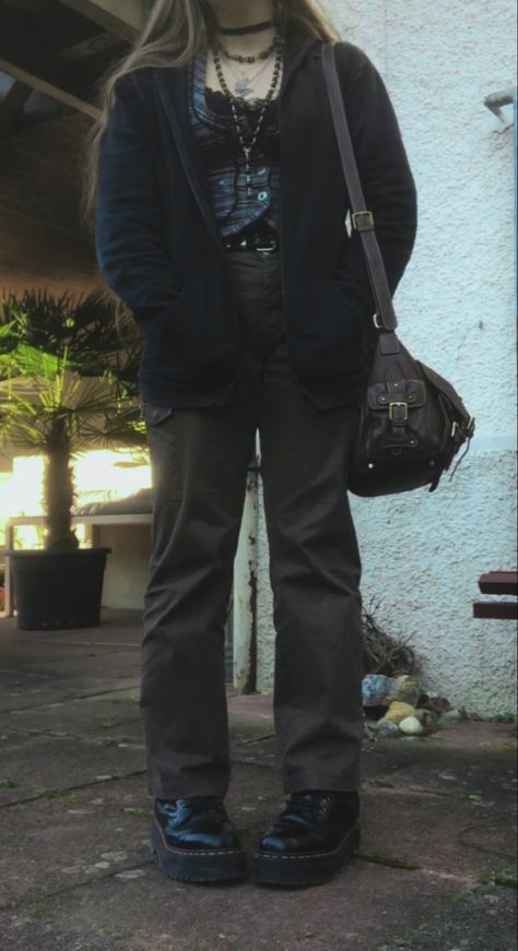 A mid-size person/girl wearing a thrifted tight grey waistcoat, a black lace tank top under it, wide dark olive green cargo pants, black platform dr. Martens and multiple crystal rings and bracelets. 	The person is also wearing multiple silver necklaces, one in form of a green crystal and another in form of a fairy  necklace, a black rosary-style bead necklace, a butterfly and a black lace choker. Wide Leg Grunge Outfit, Two Toned Pants Outfits, Fairy Grunge Cargo Pants, Cold Tone Outfit, Grunge Winter Outfits Plus Size, Fairy Grunge Pants Outfit, Winter Outfits Fairy Grunge, Fairygrunge Winter Outfits, Plus Size Grunge Outfits Winter