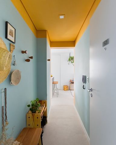 Yellow And Blue Hallway, Funky Hallway Paint Ideas, Fun Interior Paint Ideas, Painted Doorway Arch, Color Block Wall Bathroom, White Interior With Pops Of Color, Cheerful Interior Design, Small Hallway Color Ideas, Colorful Room Painting Ideas