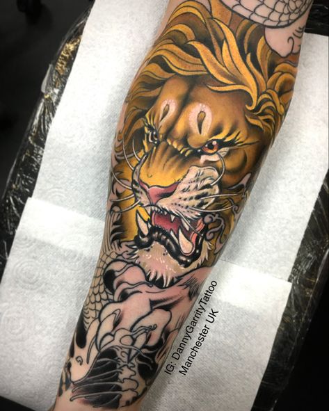 Colour neo traditional lion tattoo on men’s forearm Japanese Lion Art, Neo Traditional Lion Tattoo, Lion Tattoo Half Sleeve, Japanese Lion, Traditional Lion Tattoo, Traditional Tattoo Animals, Lion Chest Tattoo, Lion Sleeve, Colour Tattoos