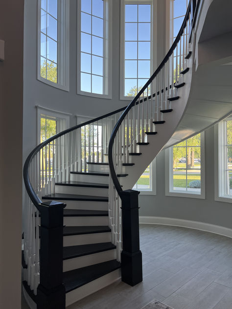 Another finished project! We love how this custom curved staircase turned out! This stairway features many standard wooden stair parts that are both painted and stained. It also has a custom winder treads made to fit the curve of this gorgeous staircase. Interested in a similar style staircase for your home? Follow the link to learn what stair parts were used! Floating Curved Staircase, Round Staircase Railing Design, Curvy Staircase, Curved Staircase Foyer, Garden Kitchen Outdoor, Stairway Railing Ideas, Gorgeous Staircase, Staircase Curved, Stairway Remodel