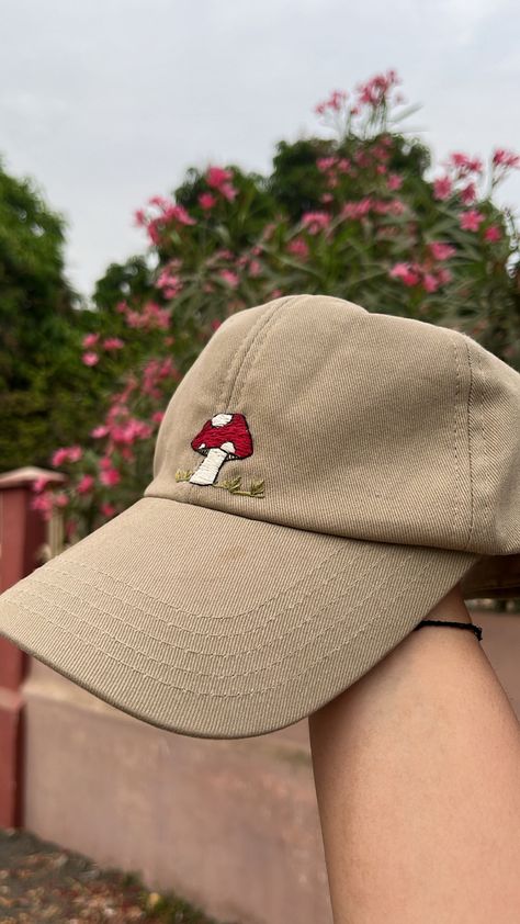 Cute little embroidery of mashroom and some grass on beige cap, i have used anchor threads of different shades fro some shadow effect #mushroom #handembroidery #baseballcap #embroidedcap #mushroomembroidery #embroideryideas Hand Embroidery Cap, Embroidered Hat Ideas, Cap Embroidery Ideas, Embroidered Hats Ideas, Beige Cap, Embroidery Jeans Diy, Cap Embroidery, Shadow Effect, Anchor Threads