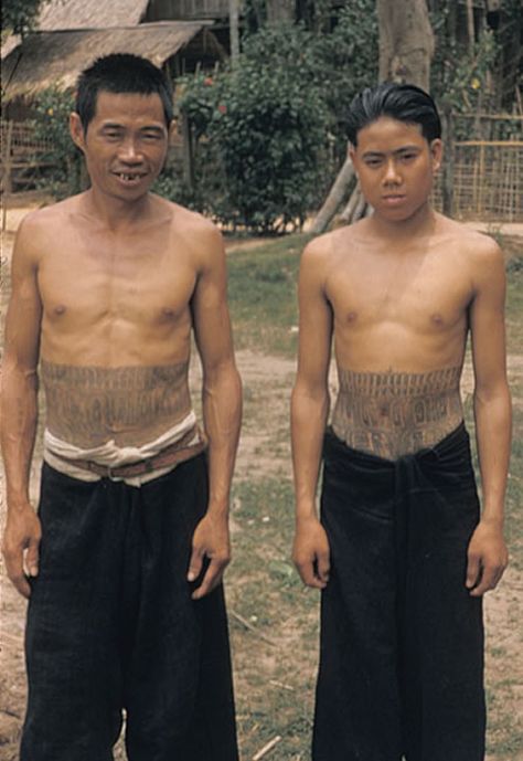 Two Laotian Kammu (Khmu') males with  tattooed midsections. The Kammu feel their tattoos enhance the prestige of an individual and they give the person protection from spirits who might otherwise "devour" a person. Their tattoos are regarded as poison to the spirits. circa 1957 #VanishingTattoo #VintageTattoos #TattooHistory Cultural Tattoos For Women, Austronesian Tattoo, Laotian Tattoo, Male Back Tattoos, Protection From Spirits, Lao Tattoo, Worldwide Tattoo, Tattoo Museum, G Tattoo