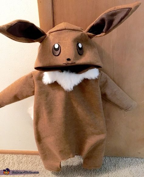 My favorite Pokémon, Eevee. I used felt and fur fabric as the materials in this costume. I used a random Halloween costume pattern to help guide for correct size and sewed as directed. For the tail, ears, and eyes, I eyeballed it's shapes measurements and attached... Photo 3 of 4. Pokemon Baby Clothes, Eevee Costume, Pokemon Costumes Diy, Grass Pokemon, Pokemon Halloween Costume, Pokémon Eevee, Halloween Costume Patterns, Aurora Costume, Baby Pokemon