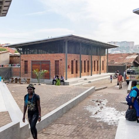 Steel canopies shade the spaces of the Kamwokya Community Centre in Kampala, Uganda, designed by Berlin studio Kéré Architecture. Sustainable Schools, Community Places, Butterfly Roof, School Hall, Canopy Architecture, Kampala Uganda, Community Halls, Community Centre, Earth Homes