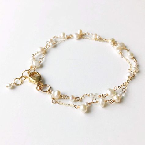 "Poppy Linen Bracelet" is perfect for our pearl lovers out there. Dainty and simple yet makes a beautiful statement. Pair it with a classic Caroline bangle for an elevated look.  - Two strands of dainty white pearls in various shapes and sizes are accented by small chain. Small, faceted crystal quartz add a hint of shi Dainty Pearl Bracelet, Delicate Gold Bracelet, Hand Jewelry Rings, Gold Pearl Bracelet, Pearl Bracelet Gold, Dainty Gold Bracelet, White Bracelet, Jewellery Sketches, White Bracelets