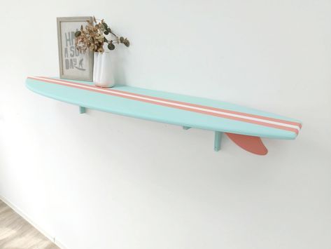 The Surfboard Shelf adds a charming and coastal touch to any room with its beach-inspired design. Handcrafted with care, this decorative surfboard shelf is made from high-quality plywood, ensuring durability and longevity. HIGHLIGHTS: - Customizable: We welcome custom orders, allowing you to choose the colors that best suit your style and preferences. - Easy to hang: Each surfboard comes with hanging hardware, making it effortless to display and enjoy in your space. DIMENSIONS: 35 x 9 inch 48 x 12 inch 60 x 14 inch If you have any questions, please feel free to contact us, and we'll be more than happy to assist you. Explore our collection of surfboards signs in our Etsy shop, where you can find more unique and captivating designs https://www.etsy.com/shop/WoodStreets Beachy Shelves, Surfer Themed Bedroom, Surfboard Shelves, Surfboard Decor Bedroom, Surfing Decor, Hanging Surfboard, Room Decor Beach, Surfboard Wall Decor, Hawaii Theme Room