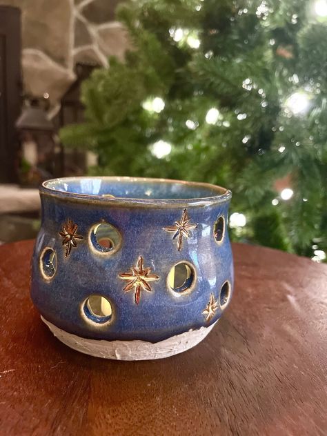 "Perfect for the winter season!  This is ceramic luminary was handmade on a pottery wheel.  It features hand carved stars that have been glazed in gold.  The base has a textured finish that is reminiscent of a snow covered ground. Each piece I make is unique and may have slight \"imperfections\" that really give it its own character.  Please see the detailed photos and videos.  And check my other listings!  Many of my pieces work well in groups together." Ceramic Snowman Handmade, Pottery For Christmas, Christmas Ceramic Decorations, Winter Clay Projects, Ceramic Carving Ideas, Luminaries Ceramic, Starry Night Pottery, Christmas Ceramic Ideas, Winter Pottery Ideas