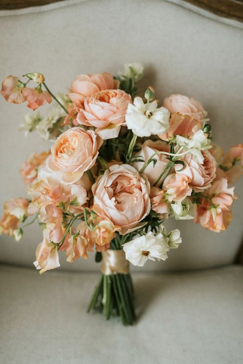 A bouquet adorned with delicate peachy and pink hues, embodying the essence of romance and love's beauty. 💐💖 Each petal tells a story of elegance and grace. #RomanticBouquet #PeachyPinkTouches #WeddingFloralArtistry #Flowers #Bridesbouquet #Love #Makehappymemories #destinationwedding Peach And Pink Bridal Bouquet, Peachy Pink Wedding Bouquet, Champagne And Peach Bouquet, Peach Peony Wedding Bouquet, Light Peach Ivory Wedding, Apricot Flower Arrangements, Beach Wedding Peach Colors, Wedding Flowers With Peonies, Peach Bride Bouquet