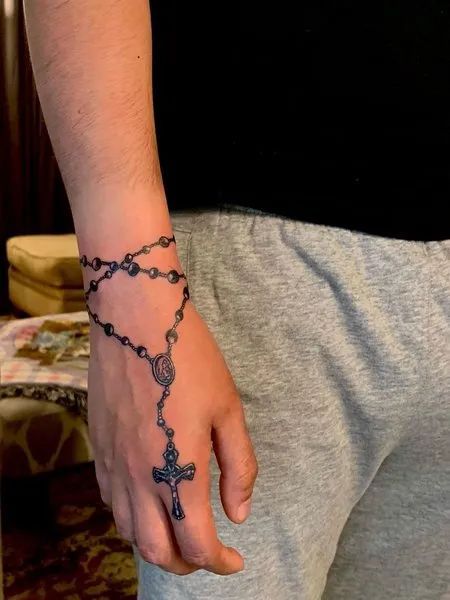 Rosary Around Wrist Tattoo, Rosery Beads Tattoo, Rosary Tattoo Ideas, Rosary Ankle Tattoos, Rosary Tattoo Wrist, Chain Tattoos, Rosary Tattoo On Hand, Tattoos On Arm, Cross Tattoo On Hand