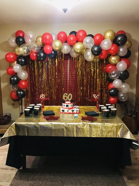 60th birthday party! Balloon garland in red, gold, black and white. Black Red And Gold Birthday Party, Gold Red And Black Party Decor, Red Black And Gold Balloon Arch, Red Black And Gold Graduation Party, Red Black White Gold Party Decor, Red Black And Gold Balloon Garland, Black Gold And Red Party Decorations, Black Red And Gold Party Decorations, Red And Gold Birthday Party Decoration