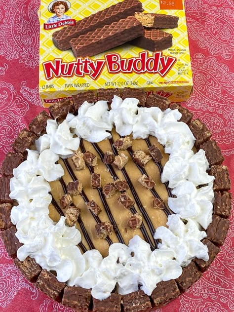 Box of Nutty Buddy bars next to a pie made from them and filled with a pudding and cream cheese mixture Nutty Buddy Pie Recipe, Nutty Buddy Cake, Nutty Buddy Pie, Nutty Bars Recipe, Nutter Butter Dessert, Cream Cheese And Peanut Butter, Pudding And Cream Cheese, Buddy Bars, Christmas Dessert Tray