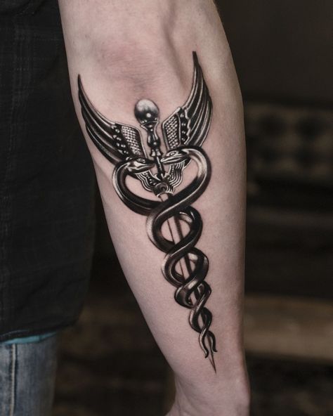 The caduceus, featuring two snakes wrapped around a staff, is an ancient and powerful symbol used in mythology and medicine. Getting a caduceus tattoo... Doctor Symbol Tattoo, Hermes Caduceus Tattoo, Staff Of Caduceus Tattoo, Staff Of Hermes Tattoo, Medical Snake Tattoo, Medical Staff Tattoo, Caduceus Tattoo Men, Hermes Staff Tattoo, Cadeusus Tattoo Design