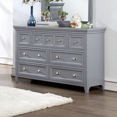 A soft gray painted finish brings an updated ambiance to this transitional seven-drawer dresser. Drawer fronts feature crown molding trim details that create wonderful texture and dimension within your stylish bedroom. They're dotted with a mix of metallic, cupped drawer pulls and round knobs for a shiny accent that allows for easy access to contents within each of the seven spacious storage drawers. | Wade Logan® Bruun 7 Drawer 56" W Dresser Wood in Brown / Gray | 36 H x 56 W x 18 D in | Wayfai Gray Dresser, Traditional Dressers, Grey Dresser, Solid Wood Dresser, 7 Drawer Dresser, Dresser Sets, Wood Dresser, Bedroom Furniture Dresser, Bedroom Dressers