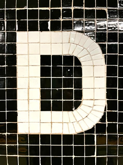 A capital D letterform made in white tile on a black background in the NYC subway system Mosaic Typography, Tile Typography, Mosaic Lettering, Mosaic Text, God Chose Me, Tile Logo, Mosaic Letters, New York Bar, Modern Baroque