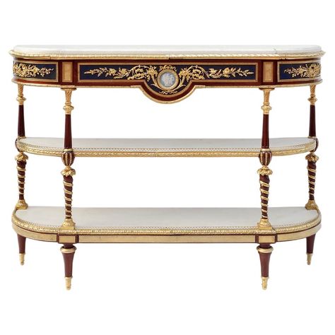 Louis XVI style console sideboard in mahogany with three flattened half-moon shaped superposed trays and a straight apron with a curved central notch. It stands on four high spinning top legs, topped by composed shaped uprights: inversed twisted and gilt balusters and fluted balusters. Rich chiselled and gilt bronze ornamentation such as notched plates, friezes of eggs and water leaves and an openwork hearts frieze balcony on the inferior tray, water leaves and grapes on uprights, laurel leaves Bronze Decor, Console Table Styling, Sideboard Console, Louis Xvi Style, French Furniture, Antique Design, Carrara Marble, Classic Furniture, Beautiful Furniture