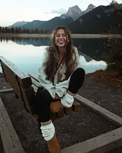 The best fall outfit ideas are the ones that are comfy, cozy, and cute! Here I’m wearing a neutral toned outfit, with a chestnut ugg tasmans, cream sherpa jacket, leg warmers, leggings, and long socks, in front of a mountain lake in Canmore!

Smile, photo inspiration, granola, girl, autumn, modest, curly long hair, layered hair, winter poses, pose ideas, bench, sitting, one leg up, tongue out, 202, 2024, eyes closed, reflection, natural makeup, casual date outfit three sisters Ugg And Leg Warmers Outfit, Mountain Date Outfit, Comfy Mountain Outfit, Cute Winter Mountain Outfits, Cabin Socks Outfit, Lake Outfit Winter, Mussoorie Trip Outfit, Cozy Mountain Outfits, Cute Winter Poses