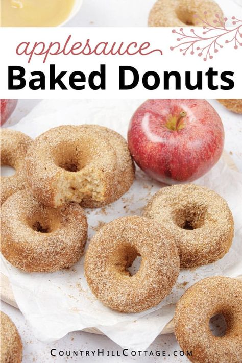 Delight your family and kids with baked applesauce donuts coated in crunchy cinnamon sugar! The easy apple donut recipe is a delicious fall treat and great for Thanksgiving brunch. Make a batch of these apple cinnamon donuts with just 7 ingredients in 30 minutes or less. They are soft and moist, super fluffy and perfectly spiced and easier than fried doughnuts. Serve these applesauce cake donuts for parties, potlucks, and whenever you need a cozy and comforting treat. | CountryHillCottage.com Applesauce Cake Donuts Baked, Apple Baked Donut Recipes, Applesauce Donut Recipe, Apple Donut Cake, Baked Applesauce Donut Recipes, Baked Apple Donuts With Donut Pan, Apple Sauce Donuts Recipe, Healthy Homemade Donuts Recipe, Apple Doughnuts Baked