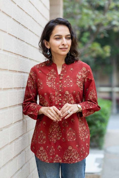 VCR259 Ridhi Cotton Short Kurti is available online at best Price at Kessa. Buy VCR259 from Kurti / Shirt - Women Clothing on kessa.com. Elevate your casual wardrobe with this charming cotton short kurti in a captivating rust Bagru color. Handblock printed motifs add an artisanal touch, while the front wooden buttons exude natural elegance. Designed with a chic collar neck and 3/4th sleeves, it effortlessly blends traditional craftsmanship with contemporary style. Sambalpuri Dress, Cotton Short Kurti, Short Kurti Designs, Printed Kurti Designs, Cotton Short Tops, Stylish Kurtis Design, Cotton Saree Designs, Simple Kurti Designs, Short Kurti