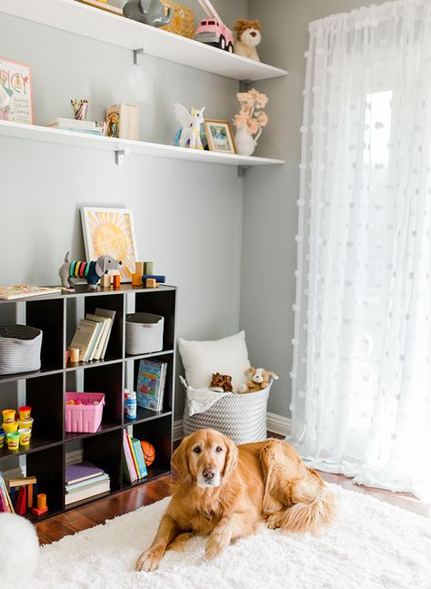 Leila, from Inspired By This, shows you how to transform your nursery into this gender-neutral kid’s playroom with the help of BEHR Paint in this DIY makeover. Leila used the light gray hue of Quiet Time, from the BEHR 2018 Color Trends, to create an open and airy feel in the interior design of her home. A bright white fur rug adds a cozy feel while open shelving provides plenty of storage. Click here to see the before and after pictures. Playroom Paint Colors, Kids Room Paint Colors, Playroom Paint, Neutral Playroom, Gender Neutral Kids Room, Playroom Makeover, Kids Rooms Shared, Neutral Kids Room, Ikea Kids Room