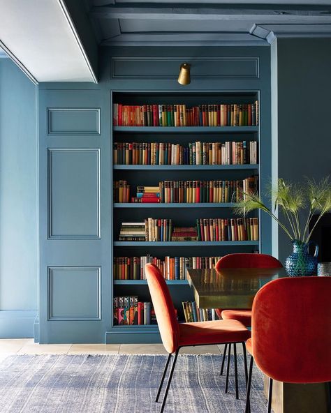 Integrated Bookshelves, Modern Home Library, Blue Library, Blue Bookshelves, Dream Home Library, Nicola Harding, Orange Chairs, Red Shelves, Blue Shelves