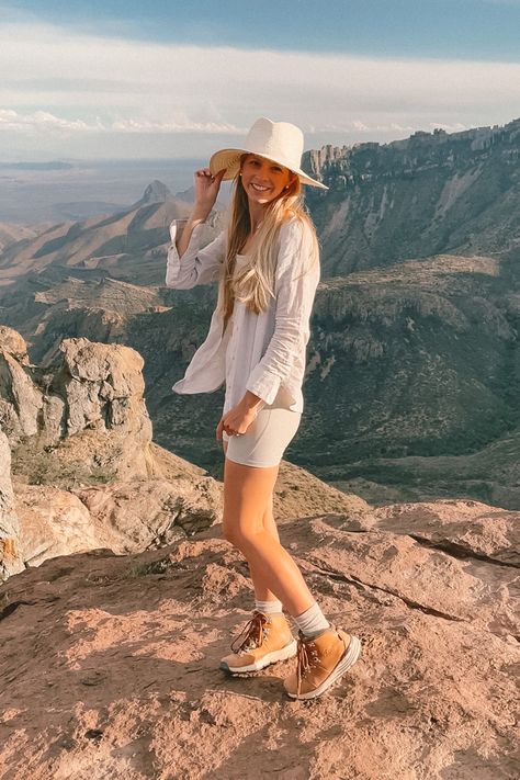 Girl in linen top, matching worker set with hat, hiking socks and Danner boots standing on cliff with incredible mountain & valley views in Big Bend National Park in Texas, USA All White Hiking Outfit, Neutral Hiking Outfit, Bridal Hiking Outfit, White Hiking Outfit, Canada Summer Outfits, Desert Hiking Outfit, Fits Socks, National Park Outfit, Outfit For Hiking