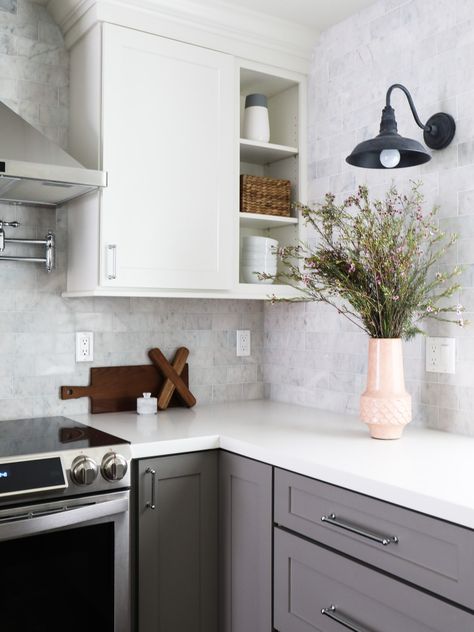 CliqStudios shaker-style Dayton cabinets in Studio Gray and White paint in partnership with blogger Brittany Makes at The Vintage Rug Shop. Gray and white shaker kitchen cabinets. Glass cooktop. White quartz countertops. Stainless steel vent hood.  White tile backsplash. Gray Cabinets White Countertops, Beach House Backsplash, Gourmet Kitchen Design, California Kitchen, White Shaker Kitchen Cabinets, White Shaker Kitchen, White Tile Backsplash, Shaker Style Cabinets, Condo Kitchen