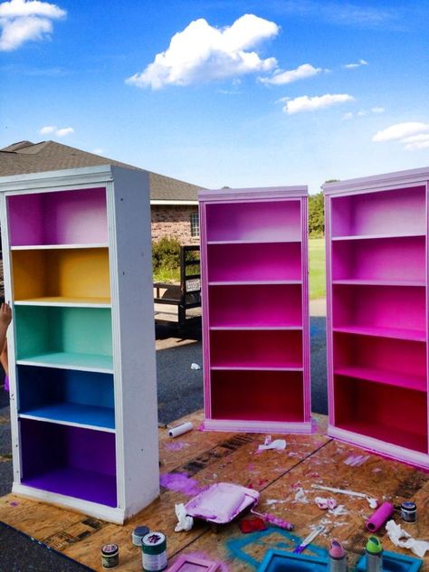 Colored book case, kids book case Rainbow Painted Bookshelf, Painted Book Cases Ideas, Cloud Couch Colorful, Eclectic Playroom Ideas, Fun Colorful House Interior, Colorful Maximalist Decor Office, Colorful Interior Decor, Funky Painted Bookshelf, Book Shelf Paint Ideas