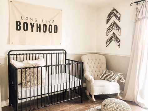 28 Charming Nursery Theme Ideas To Welcome Baby Metal Crib Nursery, Black Metal Crib, Black And Beige Decor, Gray Wainscoting, Nursery Theme Ideas, Tufted Rocking Chair, Metal Crib, Beige Decor, Crib Nursery