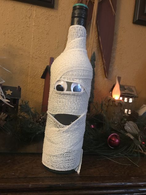 Mummy wine bottle Mummy Wine Bottle, Halloween Bottle Decorations, Ghost Wine Bottles, Halloween Bottle Crafts, Wine Bottle Halloween Crafts, Wine Bottle Mummy, Wine Bottle Halloween, Halloween Wine Bottle Crafts, Halloween Wine Bottles