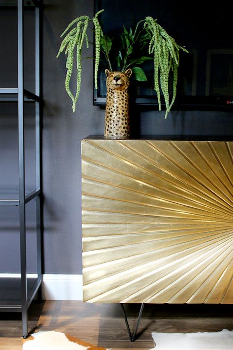 Glam Cave gold sideboard against dark walls Cheetah Sitting, Gold Sideboard, Sideboard Gold, Thursday Inspiration, Alcove Cupboards, Statement Furniture Pieces, Gold Sunburst, Affordable Interior Design, Mid Century Living