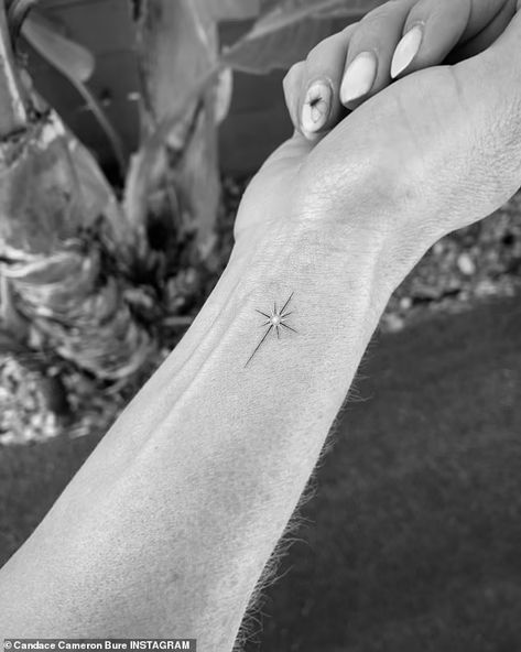 Candace Cameron Bure shows off new cross tattoo on the inside of her wrist | Daily Mail Online Delicate Cross Tattoo For Women, Dainty Cross Tattoos For Women, Tattoo Amigas, North Star Tattoo, Star Tattoo On Wrist, North Star Tattoos, Cross Tattoo On Wrist, Sparkle Tattoo, Small Star Tattoos