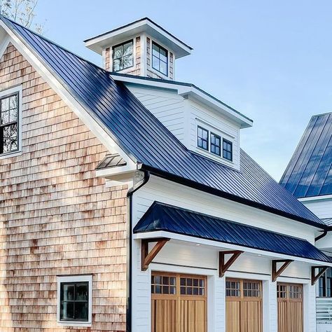 George | The DIY Warrior on Instagram: "Cedar shakes are the little black dress of exterior design.   Let’s also not forget about these beautiful Cedar Full Overlay garage doors by chioverheaddoors #chioverheaddoors   #cedar #cedarshakes #cedarshake #metalroofing #metalroof #jameshardie #chantillylace #coupula #newbuild #newbuildhome #newconstruction #newhome #waterfront #warerfronthomes #brickwork #newconstructionhomes #carolinahomes #coastalvibes #coastalfarmhouse #coastalliving #waterfrontrealestate #farmhouse #modernfarmhouse #moderndesign #exteriorhome #homegoals #housegoals #peepmypad #cljsquad" Cedar Shake Farmhouse, Garage Dormers Ideas Exterior, White House With Cedar Shake Accents, Cedar Shake And Board And Batten Siding, Cedar Shakes On Gables House, White House Black Roof Wood Accents, House Gables Exterior, Brick And Cedar Shake Exterior, Cedar Gables On House Exterior