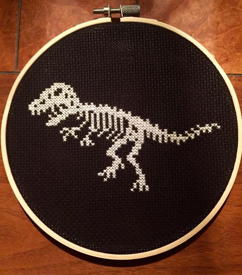 Cross Stitch Dinosaur, Black Cross Stitch, Dinosaur Cross Stitch, Cross Stitch On Black Fabric, Dinosaur Cross Stitch Pattern, Cross Stitch Black Background, Cross Stitch Patterns Black Background, Jurassic Park Cross Stitch Pattern, Skeleton Cross Stitch