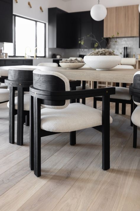 Experience the harmonious fusion of classic style and contemporary materials with our Keeler Dining Chair. Its black mindi wood frame seamlessly complements the uniquely textured off-white poly blend upholstery, creating a visually stunning combination. The seat is adorned with padded cushions that not only provide exceptional comfort but also enhance its aesthetic appeal. Dimensions: 22.5" W x 23.5" D x 32.5" HSeat Height: 17"Materials: Mindi Wood, Polyester Blend UpholsteryFinish: Ebony, Off-W Black Table Design, Black Neutral Dining Room, Black White And Tan Dining Room, Black White And Green Dining Room, Black And White Modern Dining Room, Dining Chairs For Black Table, Black And White Dining Chairs, Neutral And Black Dining Room, Beige And Black Dining Room