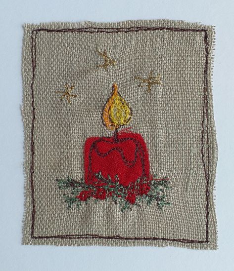 A detailed Christmas card featuring a red candle from appliqued fabric with details added in different coloured threads using free motion embroidery. Stars in gold, pine branches and red berries, and a flame in yellow and orange threads. The design is stitched on to beige linen, then sewn directly on to the card.  The card measures 21cm high and 10cm wide, comes with a white envelope and in a cellophane bag for protection. Inside is left blank for your own message.  Please note that this is a ha Hand Stitched Christmas Cards, Free Motion Embroidery Christmas, Handmade Fabric Christmas Cards, Applique Christmas Cards, Stitched Christmas Cards, Sewn Christmas Cards, Quilted Christmas Cards, Embroidery Christmas Cards, Embroidered Christmas Cards