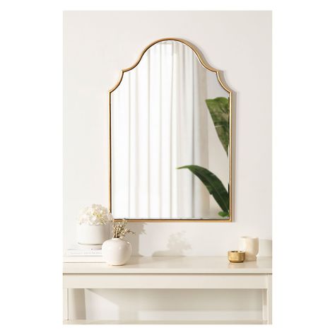 Showcase your glamorous, elevated aesthetic in your home by hanging the Leanna mirror on your wall. Inspired by the elegant curvature of sophisticated vintage art pieces, the Leanna features an arched shape with a scalloped edge on either side. Along this beautiful frame, you'll find a jaw-dropping gold leaf finish that was applied by hand, giving it a customized, one-of-a-kind look that radiates decadence. The overall dimensions of the Leanna wall mirror are 20" wide by 30" tall, making it a stellar statement piece for any wall in your home. Use the lovely Leanna mirror to elevate elegance in your living room, bedroom, entryway, or dining room. It captivates your guests as its own focal point or dazzles in a display of multiple mirrors. The ample surface area of this mirror allows it to s 2023 Apartment, Glamorous Bathroom, Multiple Mirrors, Apartment Vibes, Hampton House, Framed Wall Mirror, Gold Bathroom, Framed Mirror Wall, Mirrors Wayfair