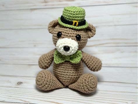 Crocheted teddy bear for St. Patrick's Day. Crochet bear sits about 7" tall without hat, wearing a leprechaun hat and green bow tie, Amigurumi St Patricks Day, Leprechaun Crochet, Crochet Irish Leprechaun, Amigurumi Bear With Hat, Crochet Bear Head Keychain, Crochet Bow Ties, Sewing Hats, Green Bow Tie, Leprechaun Hats