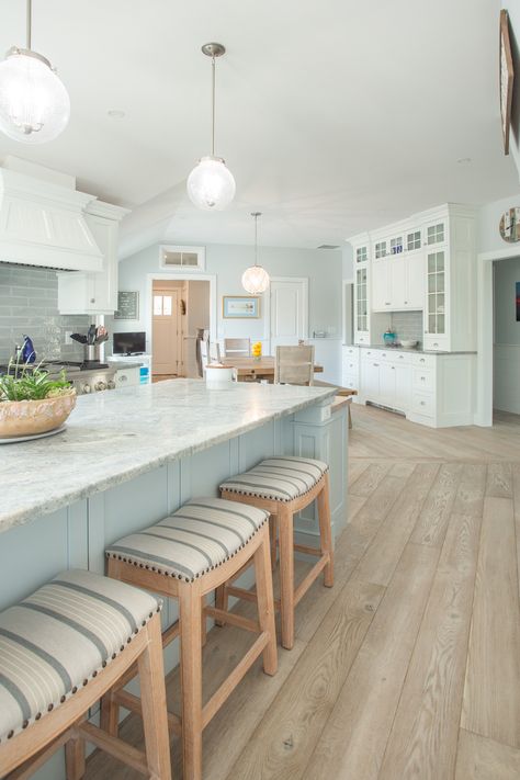 Check out this stunning coastal kitchen! Lighthouse flooring from the Shoreline Collection helps maintain the clean and airy feeling of the space. Grey Wood Flooring, Small Coastal Kitchen, Flooring Wide Plank, Beachy Kitchens, Beach House Flooring, Coastal Flooring, Coastal Cottage Decorating, Coastal Kitchen Design, Beach House Interior Design