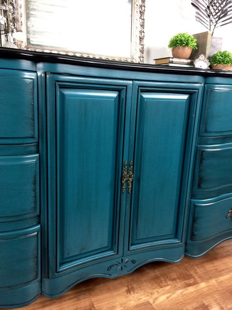 This gorgeous French Provincial dresser was chosen out of our unfinished inventory and customized!  She had a hard time choosing a color for her space.  After much deliberation and color mixing we came across this perfect shade of teal!  We used a combination of Coastal Blue, Emerald, Klein Blue, and Patina Green milk paints along with a splash of Summertime Blue Chalk Style paint to complete it!  We then sealed it with HP Satin and glazed the whole piece with Pitch Black Glaze Effects.  The ... Teal Painted Furniture, Teal Furniture, Provincial Dresser, Patina Green, Painting Antique Furniture, French Provincial Dresser, Green Milk, Teal Kitchen, Teal Paint