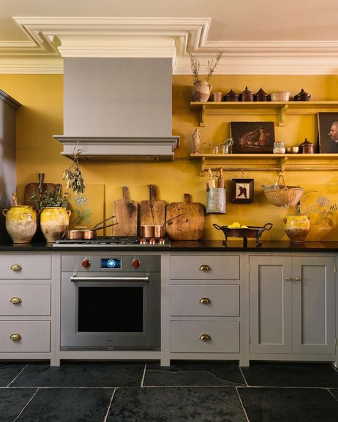 Sunny yellow walls and a wonderful collection of old pots and chopping boards and copper pans. Our little bit of the Mediterranean in New… Ochre Kitchen Walls, Kitchen With Yellow Walls, Devol Shaker Kitchen, Popular Kitchen Colors, Shaker Kitchen Design, Best Kitchen Colors, Серая Кухня, Devol Kitchens, Fun Kitchen